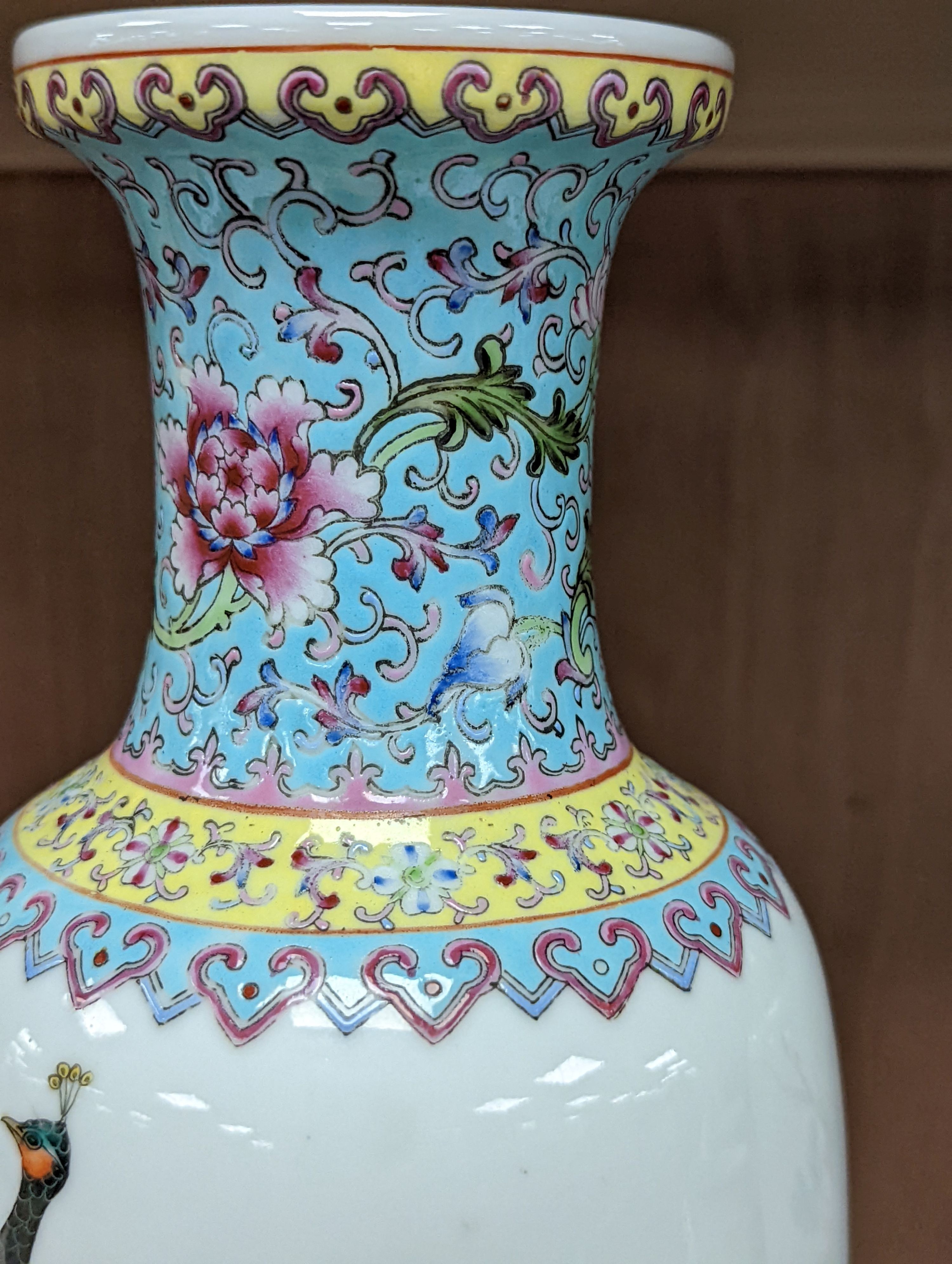 A pair of Chinese famille rose vases decorated with peacocks, 31cm